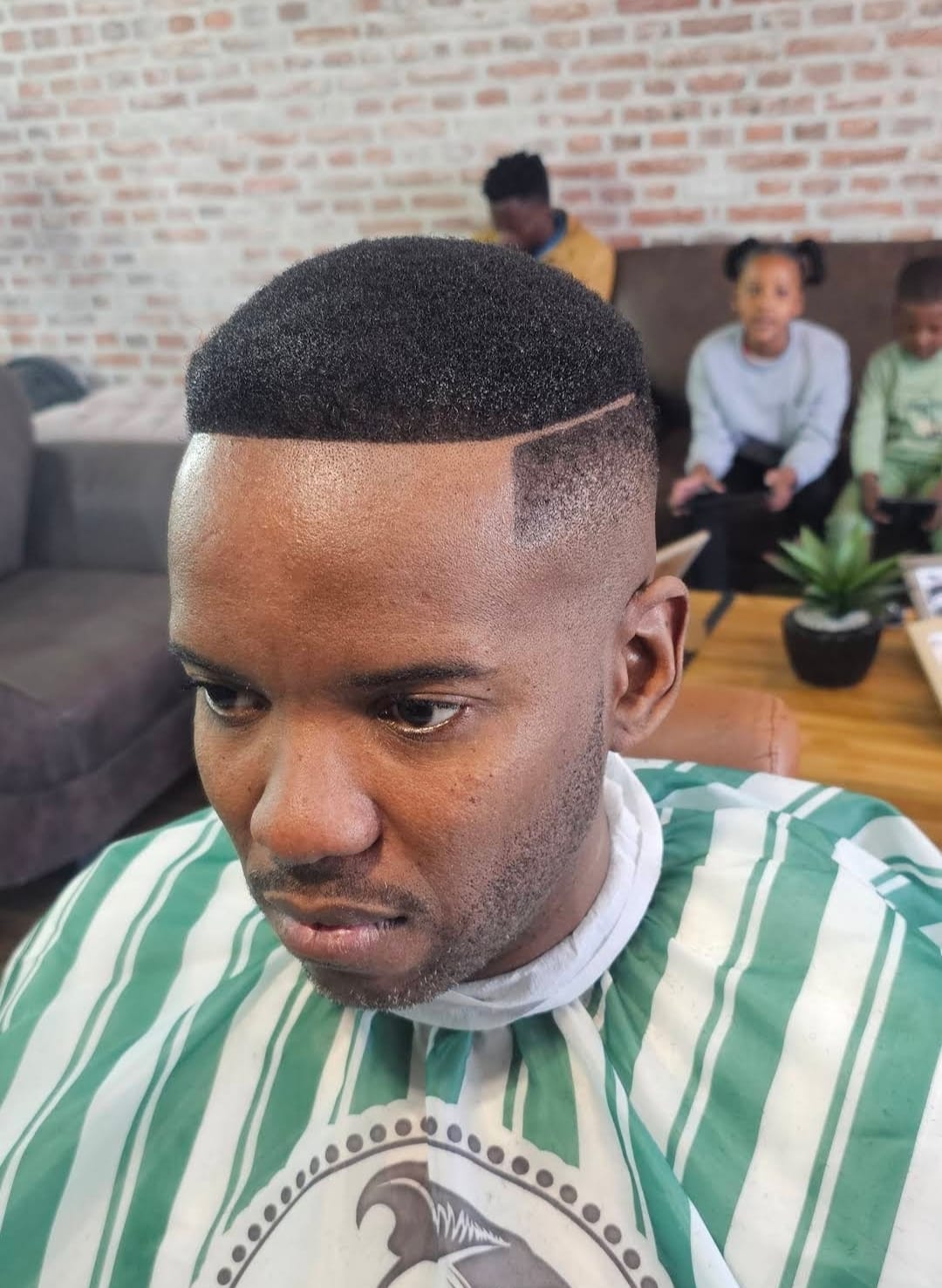 Buzz cut with hard part design