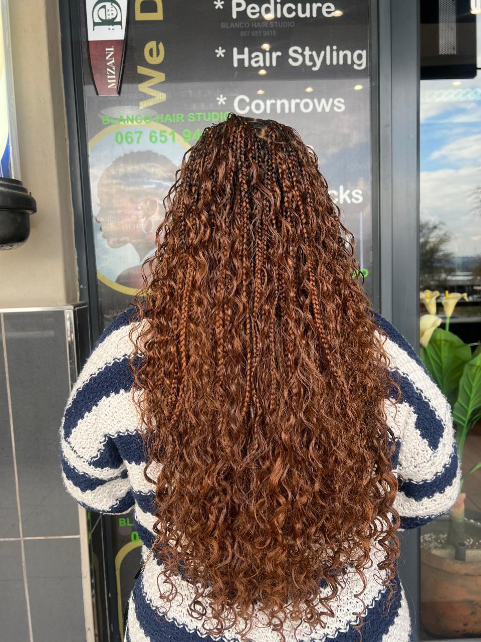 Copper curly braids back view